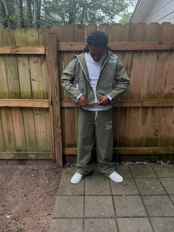 Customer in an olive One Chance track set