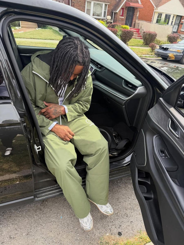 Customer in a sage green One Chance set stepping out of a car