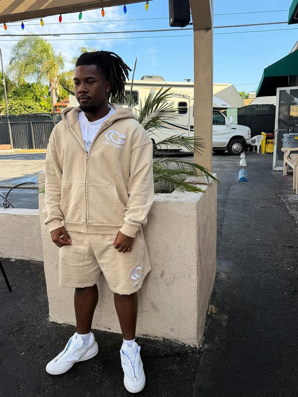 Customer in a tan One Chance zip hoodie and shorts
